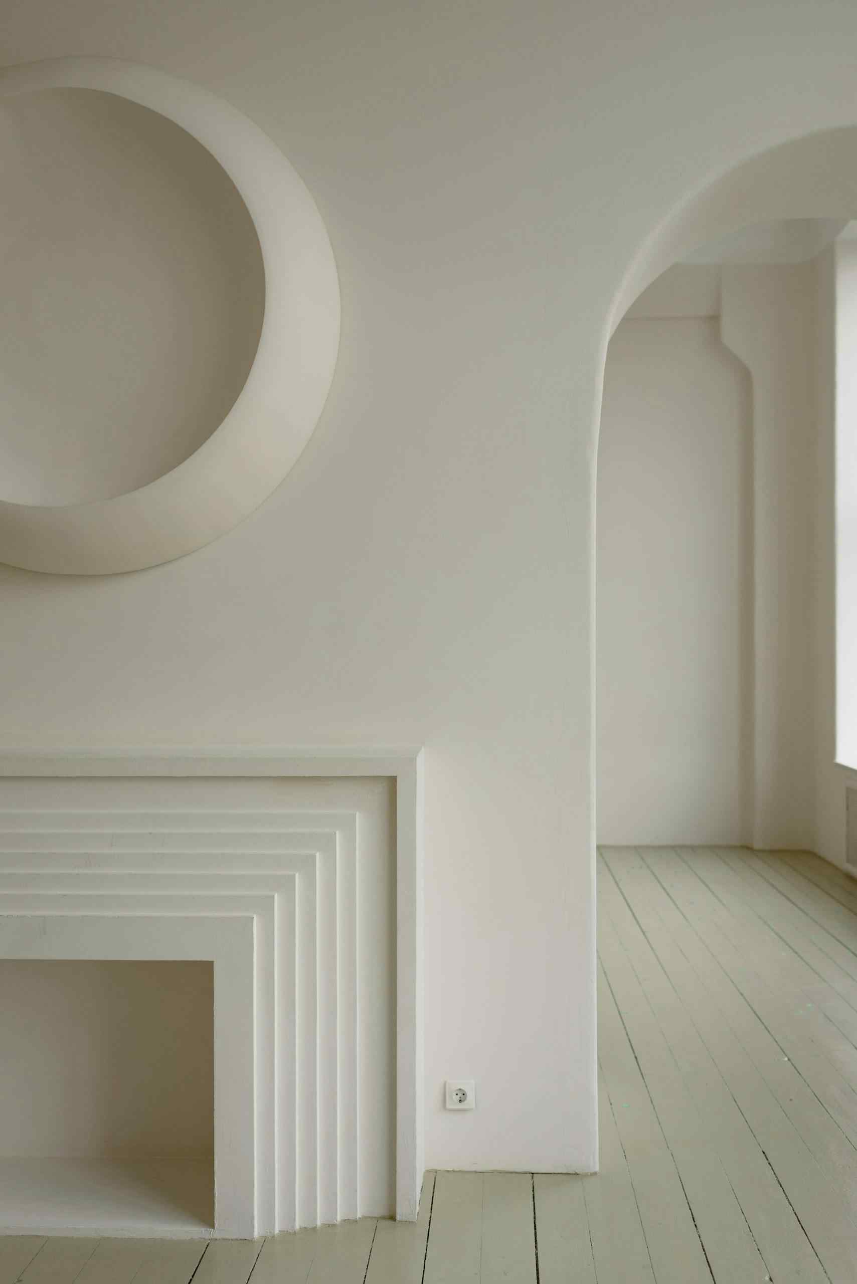 Modern minimalist room showcasing white geometric architectural details.